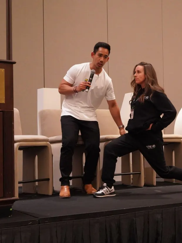 Dr. Rodante Saballa guiding a movement demonstration at a conference.