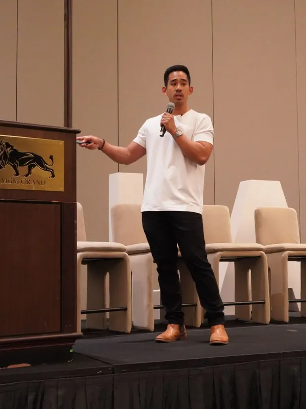 Dr. Rodante Saballa presenting on stage at a conference.