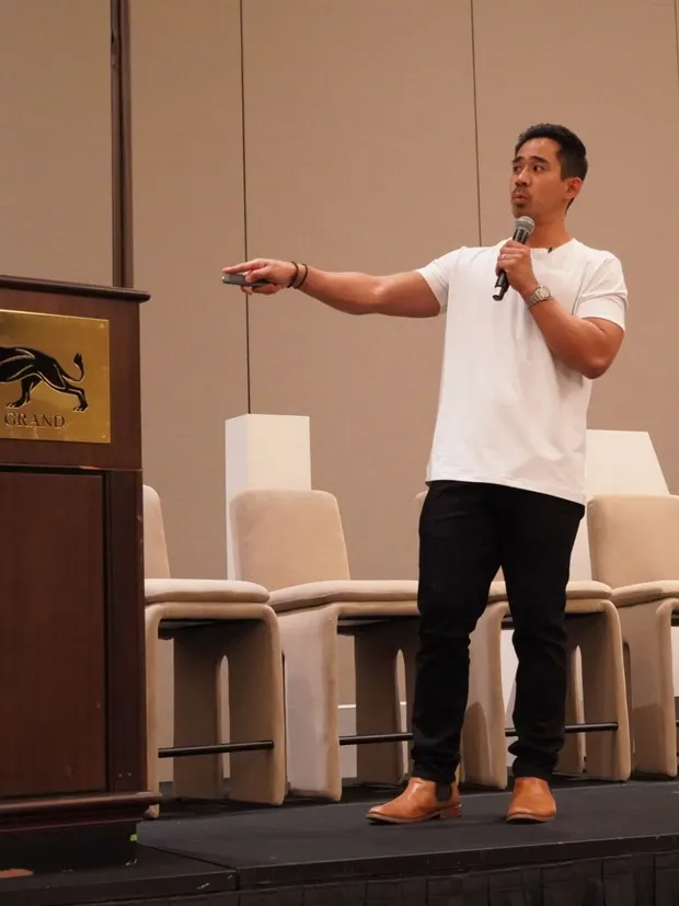 Dr. Rodante Saballa teaching from the stage, mid-gesture.